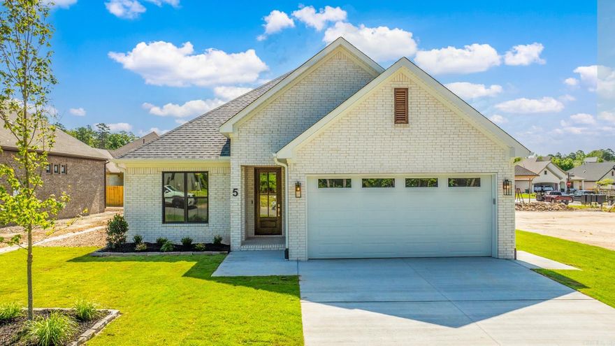 Welcome to Woodlands Park, where neighborhood charm meets suburban convenience.This thoughtfully designed home by Graham Smith is currently under construction with an anticipated completion date of July 2024. As you step inside to an open concept living area you will find tasteful designer finishes throughout. The heart of the home is the kitchen, featuring custom cabinetry, stainless steel appliances, and a large island with a breakfast bar. The primary suite is complete with a walk-in closet & an en-suite bath featuring a double vanity, a soaking tub, & a separate shower. Two additional bedrooms & a shared full bath offer plenty of space for family or guests. The covered patio is perfect for enjoying the serene surroundings and you can rest easy knowing you will never have to mow again. Lawn care is included when you are a homeowner at Woodlands Park. Enjoy this beautiful new home, convenient location, and all WLR has to offer! Welcome Home!