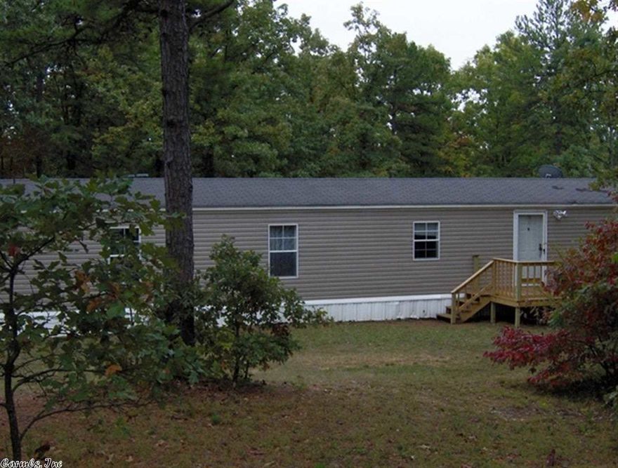 Very nice 16' x 80' Mobile home setting on 3 acres. Home has 3 bedrooms and 2 bathes. Master bedroom has king size bed that will stay with home. Master bath has jet tub. Home is all electric central heat and air with wall mount gas heater for extra protection in case of power outage. Home has two new wooden decks front and back. Two car portable carport to remain with home