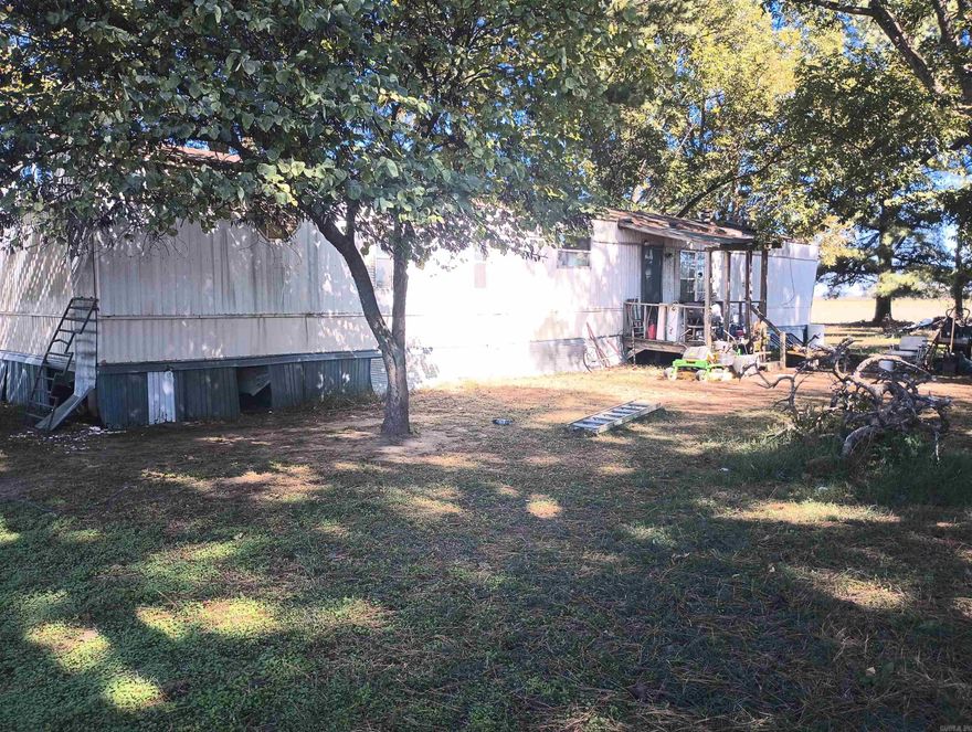 14x70 2BR, 2BA mobile home on 0.46 acres (m/l) in the Mounds community. Long term Tenant. Situated on large shady lot on the corner of Hwy 139 and GR 870 Rd. Long term tenant. Monthly rent is $400.00. Sold AS IS. SEE AGENT REMARKS.