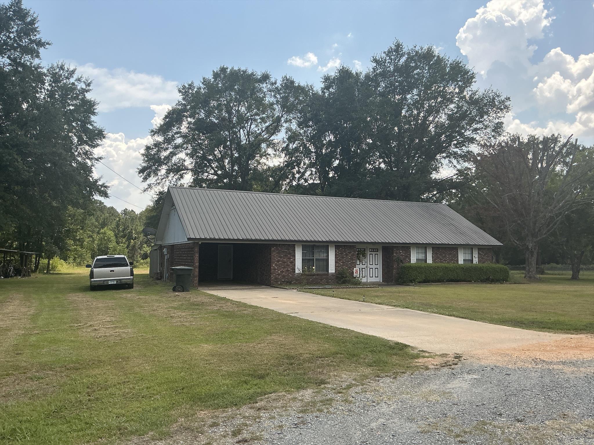 Beautiful home with 1562 Sq Ft sitting on 5.85 Acres with a pond located just minutes from city amenities, major employment, schools, shopping, move-in-ready just waiting for you and your family. Home features large living area open to the dining room and kitchen with a breakfast bar, lots of cabinets, stove, refrigerator and a place for a dishwasher. Flooring is luxury wood vinyl and carpet, neutral colors through home and the 3 bedrooms feature large closets with the master featuring a walk-in closet. The remodeled bathroom features shower over surround bathtub, and luxury wood vinyl floors. The large laundry room has room for a freezer and a new electric tank-less water heater has been installed. A covered patio also has a place for a hot tub (hot tub does not remain with the property) and there is a shop with a lein-2 for parking lawn mowers, etc. This is one home you must see to know all the amenities this home offers.