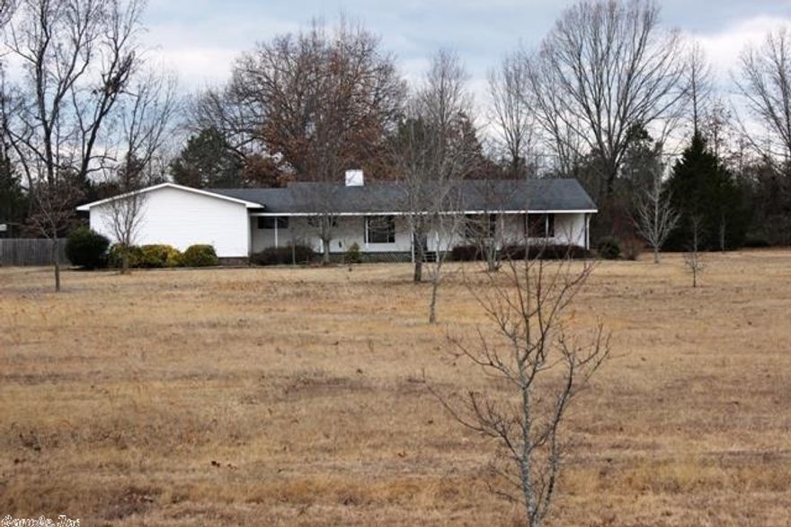 Great Home on 5 Acres with 4 car Garage! 3 bedroom, 2 bath home features Family room with wood burning fireplace, large kitchen with huge island and lots of cabinets. Master bedroom has 2 large walk in closets. Huge utility room with lots of storage and covered deck with sunroom to enjoy the spring weather. Lots of space in the huge Yard which has fruit trees and blueberry bushes.  Perfect home for someone who wants to add a little TLC!
