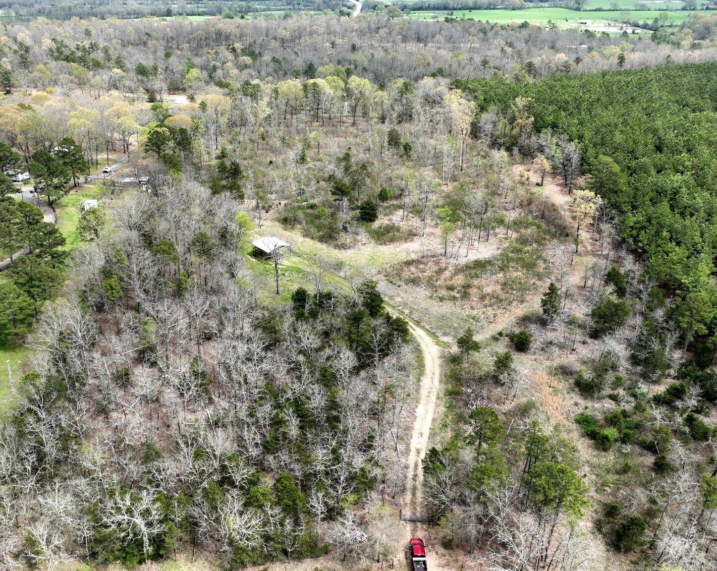 Build Your Dream Cabin or Vacation Escape! Looking for the perfect place to escape the hustle and bustle? Whether you're dreaming of building a cozy getaway cabin, a full-time residence, or setting up a basecamp for outdoor adventures, this property offers the ideal blend of seclusion and convenience. Enjoy easy access to the renowned Wolf Pen Gap ATV trails, just a short ride away – a paradise for ATV enthusiasts and outdoor lovers. Surrounded by natural beauty, this land invites you to wake up each morning to the peaceful sounds of nature and breathtaking views of the mountain tops. A mix of open space and wooded areas, offering flexibility for building or recreation. Property comes with an operational water well and electric service already in place. A solid 30' x 30' all-metal covered awning provides the perfect shelter for your camper while you build or just enjoy a weekend getaway. Property was purchased with the understanding that a septic system exists, though it has not been located by the owners. Only a few minutes’ drive to the heart of Mena, where you’ll find shops, restaurants, etc. Close to national forest , hiking, fishing spots, and recreational opportunities.