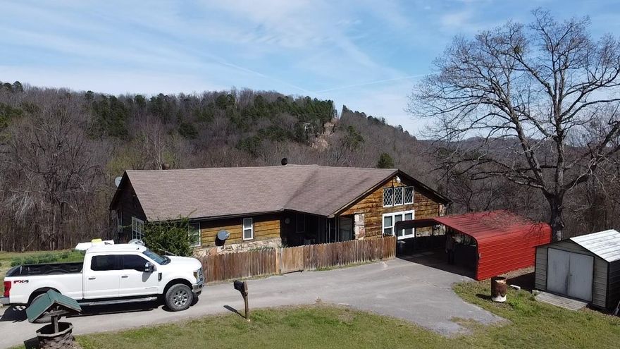 Experience Ozark Living on 30 private acres with breath taking mountain views This 3 bed, 1.5 bath home offers an open living/kitchen, and dining space anchored by a native stone fireplace and custom built in bookshelves. Designed for both comfort and function, the home includes a whole house generator and a reporting security system with strategically placed video surveillance cameras. A large laundry room and primary bath features a walk in tub to add everyday ease. Enjoy quiet mornings on the back deck overlooking the abundant wildlife and beautiful mountain sunrises. Also includes multiple outbuildings and storm cellar for added storage and safety.