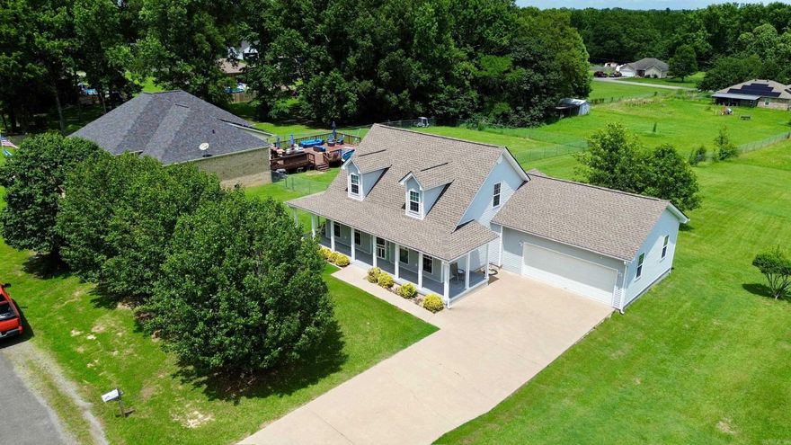 Welcome to this beautifully maintained 3 bedroom, 2.5 bathroom home on an oversized lot just outside the Cabot city limits. Enjoy peaceful country living with the convenience of nearby schools, shopping, and dining. A charming wraparound porch with durable Masonite decking and built-in speakers is perfect for relaxing or entertaining. Step inside to a soaring two-story entryway and gorgeous wild cherry hardwood floors throughout the main living areas. The kitchen offers stainless steel appliances, a pantry, and plenty of cabinet space for all your cooking needs. The primary suite is conveniently located on the main floor, while two additional bedrooms upstairs share a Jack and Jill bath. A separate powder room on the first floor is perfect for guests. With a roof less than three years old, a spacious layout, and move-in ready condition, this home has it all — extra space, privacy, and an easy drive to everything Cabot offers.