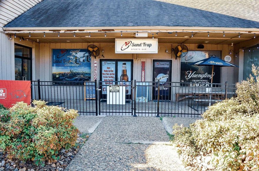 This is your ultimate local hangout-a full service restaurant and sports bar where the game is always on and the food hits the spot. With wall to wall Tv's showing every major sporting event, a wide selection of liquor, cold beers on tap, and a menu full of specialty items, we're the perfect place to grab dinner, catch the game, or unwind after work. Whether you're flying solo, out with friends, or celebrating a win, the Sand Trap delivers great vibes, bold flavors and non stop sports action-all in one convenient location. Come for the food, stay for the game!  Includes a fully equipped kitchen, POS system, Music Bingo System, Strong local reputation & loyal clientele Seating capacity 60+ outdoor patio space Building is currently leased by owner and sq. footage is approximate- total expenses, taxes and property details to be provided to interested parties upon request.