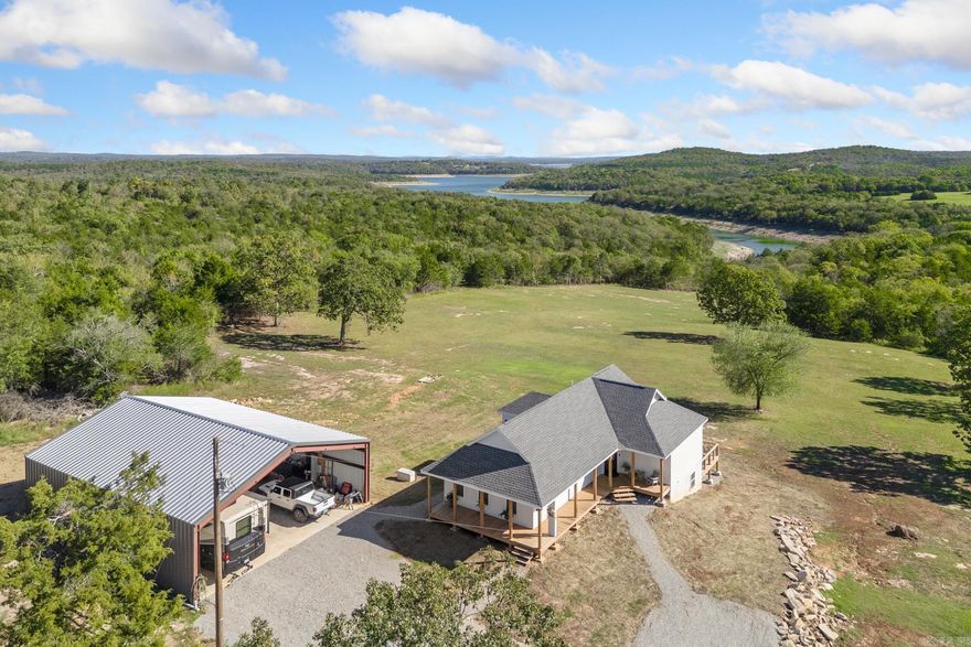 Brand-New Lakefront Retreat on 12+/- Acres with Stunning Bull Shoals Views! Built in 2025, this gorgeous 2-bedroom, 2.5-bath lakefront home perfectly blends modern comfort with natural beauty. Nestled on over 12 private acres, this property offers panoramic views of Bull Shoals Lake and easy walk-to-the-water access. Step inside to a bright, open floor plan with a cozy gas fireplace, a dreamy kitchen overlooking the lake, and multiple decks designed to soak in the incredible views from every angle. The unfinished walkout basement offers endless potential — create additional living space, a game room, or guest suite, tailored just for you. Outside, you have a 40x50 red iron shop building for all your toys, tools and hobbies, plus your own private well and plenty of room to roam. Whether you’re seeking a peaceful getaway, full-time lake home, or a retreat for family and friends, this property offers it all! Come experience lakefront living at its finest — where every sunrise feels like a personal show just for you!