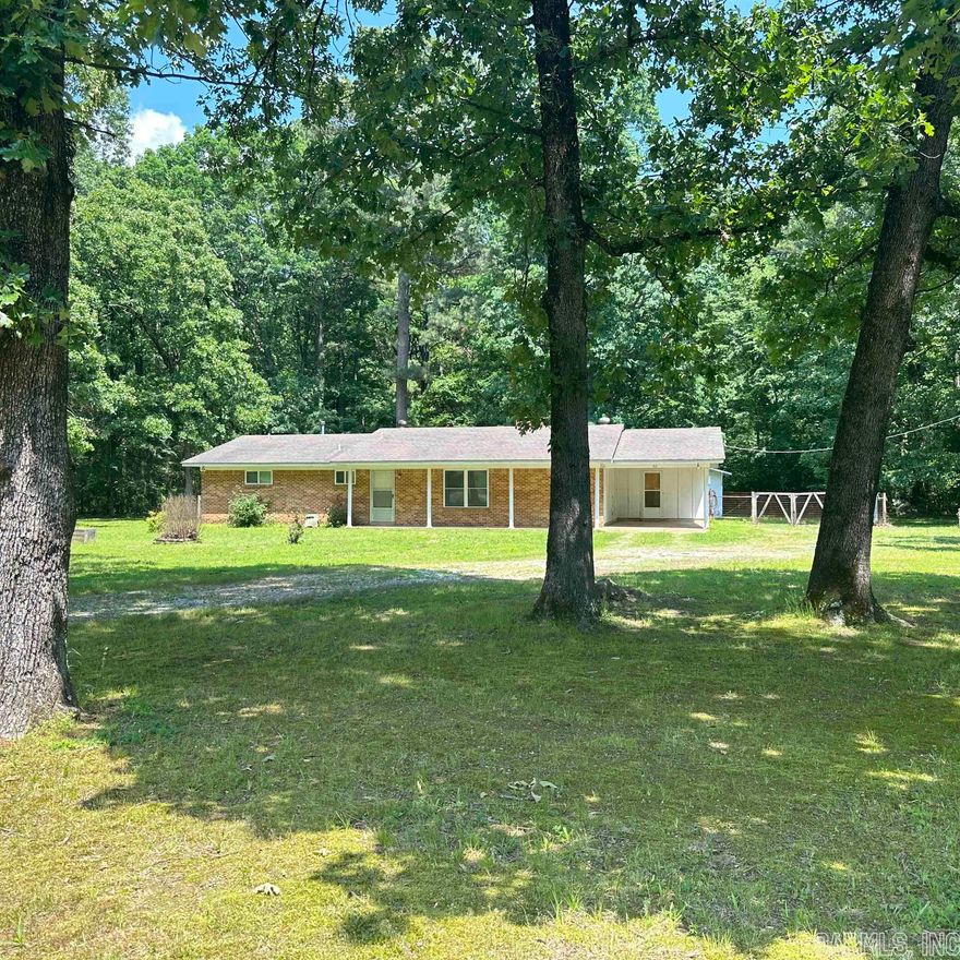 Nice country home just minutes from town. Large yard with fenced in back yard, Storage Building and Beautiful large shade trees in front.  3BR/2BA Home with Spacious Living Room with wood burning insert fireplace.  Extra Living Area that could be Den or Formal Dining Area.  Kitchen area offers tons counter and cabinet space, and refrigerator, washer, and dryer convey with property.  New Laminate Flooring, with extra left for new buyer.