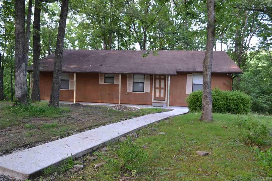 A stream runs through it! Dreaming of a country home on top of a hill with a stream on the back side of 5 beautifully wooded acres?! Then you just found it! Two large decks to enjoy the views of your peaceful retreat. Large open layout great for entertaining, vaulted rustic beam ceilings, updated master bath with tile shower, jacuzzi and separate dressing room!  Want more? How 'bout a 17'x32' newly refinished walkout basement as game room,media room or huge man cave! Fireplace, storage bldg, & security sys!