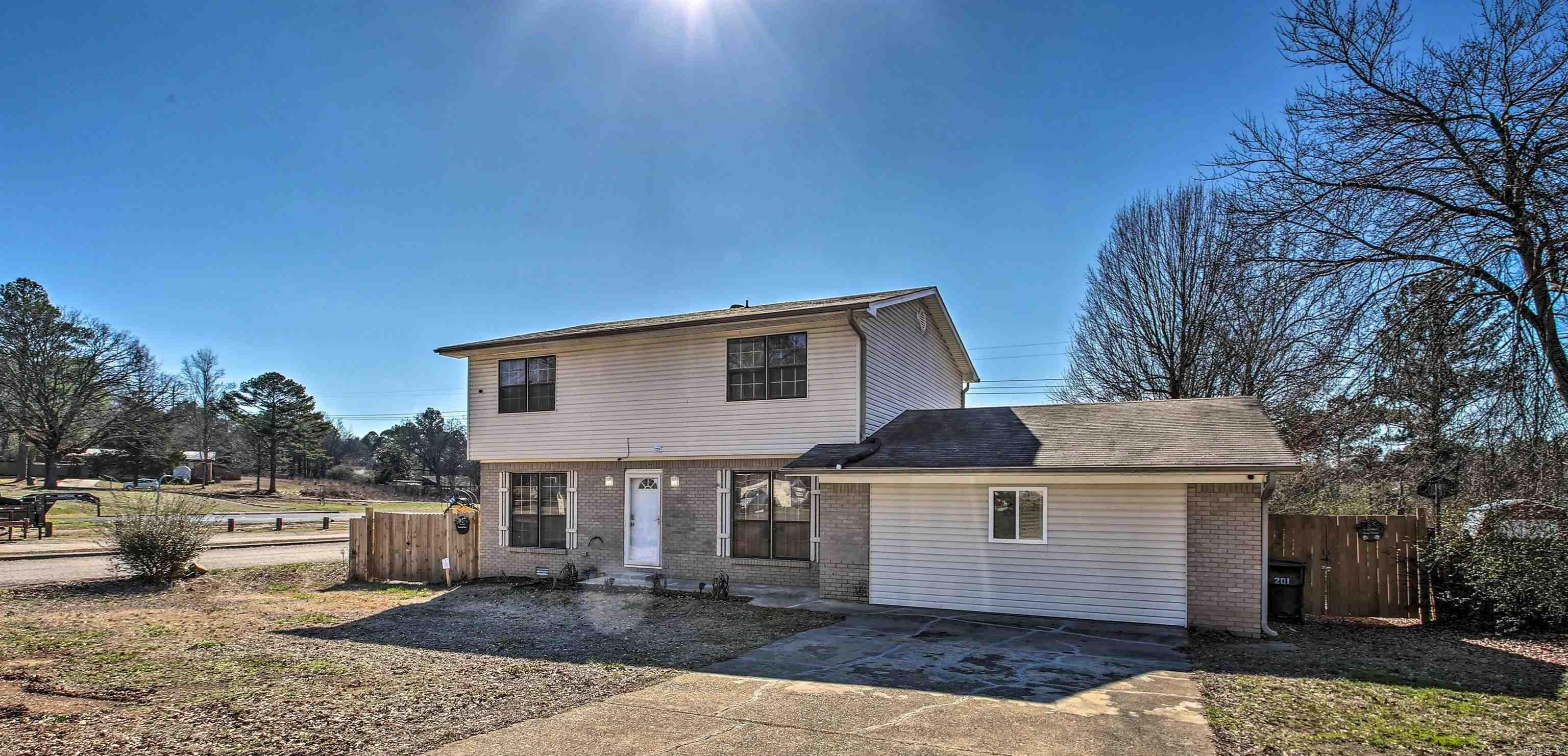5 BEDROOM, 3 BATH HOME ON A CORNER LOT! This spacious 2400+ sq ft home offers the perfect blend of privacy and proximity to top attractions. Ideally situated near the Mid-America Science Museum, downtown Hot Springs, and a variety of outdoor adventures, this home blends peaceful living and adventure. With an eat-in kitchen, separate dining room, and multiple living areas there's plenty of space for hosting family and friends. There's also a covered back deck - ideal for outdoor dining, barbecues, or simply soaking in the peaceful atmosphere. Nestled in a quiet neighborhood within the Lake Hamilton School District, this property is perfect for those seeking both convenience and serenity. The backyard is spacious and private, enclosed by a three-year-old fence, and includes a large storage building for added functionality. Home can be used as a short term rental and has been used to host large gatherings. Plenty of potential and opportunity here! Schedule your showing today!! Bonus space added in 2022. Furniture is negotiable. Agents - Call Showing service to schedule all showings.