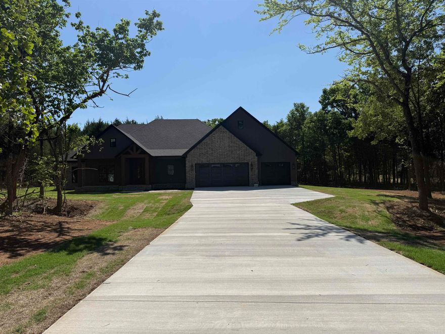 This home is located in a brand new subdivision in Greenbrier. It has a very large backyard with trees to buffer the view of the neighboring homes. The large back porch is great for entertaining. Inside the home you will find high ceilings and large windows.  Abundant cabinetry with a hidden pantry with shelving for all the items that you don't want to be seen on your countertops. Granite countertops throughout the home. Enjoy the view from the living room into the backyard while sitting in front of the cozy fireplace. Coming in from the garage is a half bath with lockers for coats, shoes and bags. You can circle through the laundry room into the primary closet through the bathroom and into the bedroom. You will enjoy the soaking tub and separate shower. You will appreciate the storage in this home! The 3rd car garage is extra deep for a trailer, boat or extra storage.