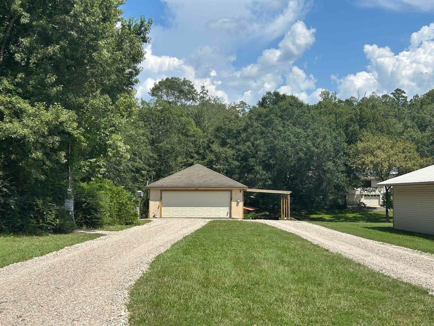 Welcome to this lake front lot situated on Lake Hamilton that has year round water.  The property features RV hookup and parking, a clubhouse that has electric, water and a full bathroom.  The property will not perk due to when they dreddged the canal, the lot received an extra amount of clay/silt.  The clubhouse bathroom does have an electric urinal and an electric Cinderella incinerator toilet.  The property also features a one car carport with electric charging station, automated garage door on clubhouse and the property line extends 5' over onto neighboring shoreline boardwalk with stairs.  Washer/dryer combo conveys.  Property will allow for a one stall boat dock.  Lake Hamilton school district.  Owner financing available.