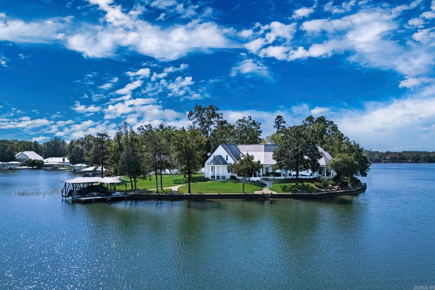 Savor sparkling Lake Balboa views from almost every room at this waterfront retreat. Soaring floor-to-ceiling windows flood the living areas with natural light and frame postcard panoramas, while a covered back veranda invites effortless indoor–outdoor living. A private boat dock puts lake days at your doorstep. The spacious primary suite opens directly to the back patio—perfect for morning coffee or sunset unwinding. Practical perks abound, including a 3-car garage and circle drive for easy parking and guest arrival. Thoughtfully designed for relaxing weekends or everyday living, 8 Adoracion Point blends serene water vistas with comfortable, elegant spaces—your Lake Balboa lifestyle starts here. In addition the lifestyle of Hot Springs Village gated community features golf, hiking, pickleball and beautiful natural scenery.