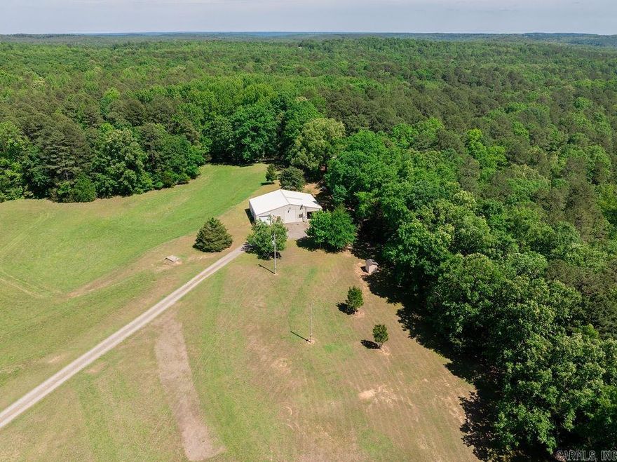 Set on 44 acres between Pangburn and Heber Springs with paved access, this property offers a rare blend of privacy, functionality, and natural beauty just minutes from Greers Ferry Lake and convenient to the world-renowned trout fishing waters of the Little Red River. The land is partially cleared with wooded sections, ideal for livestock, gardening, or future improvements, and features a private pond that adds both scenic charm and recreational use. The 2 bedroom, 2 bathroom barndominium provides comfortable living with a functional layout, including an optional office or small third bedroom and easy-access attic storage. It also features pull-through garage space with two automatic doors and a covered front porch patio overlooking the peaceful wooded setting, making it well suited for full-time living, a weekend retreat, or a hunting base. Additional improvements include a storm shelter, detached outbuildings for storage, and a second septic system already in place for a mobile home or RV, offering flexibility for guests or rental potential. Abundant wildlife such as deer and turkey further enhance this quiet country property. Call your agent today to schedule a tour.