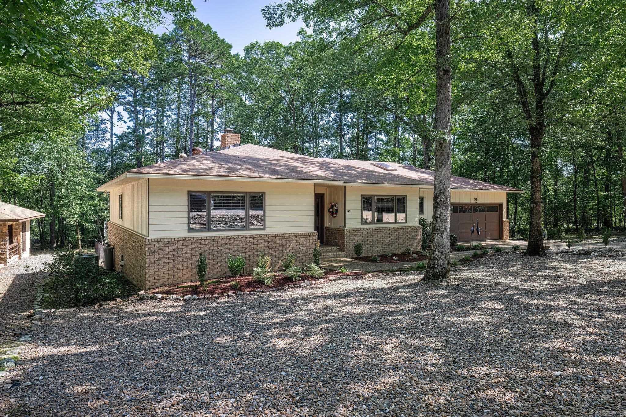 What a great home!. New roof in 2021, new deck in 2021, new paint in 2021, new heat pump in 2022. This awesome home has hardwood flooring in living room, dining room, and bedrooms. Lage formal dining room off living area, nook off kitchen. Kitchen has beautiful wood cabinets and quartz counters, pantry with pull outs. More than ample space. Laundry off kitchen. Two bedrooms with tons of storage!! There is also an AR room with built in desk and entertainment area. (most of us turn that third bedroom into an office...so you are all set). Wood windows, new quartz in baths. New flooring in kitchen. Newer light fixtures, ceiling fans, skylight in kitchen, sun tube in AR room and Primary suite. Garage has MORE storage and work bench. Fenced in back yard for your fur babies. Very ample deck for your outside enjoyment. Exceptional Hot Springs Village is a 26000 acre gated community with 11 lakes 9 golf courses, pickle ball, tennis, white sand beach, 2 marinas, fitness center, hiking trails, indoor and outdoor pools. Visit the Woodlands for musical entertainment, get your produce on Thursday morning at the Farmers Market. 2 Restaurants with decks overlooking lakes. Paradise
