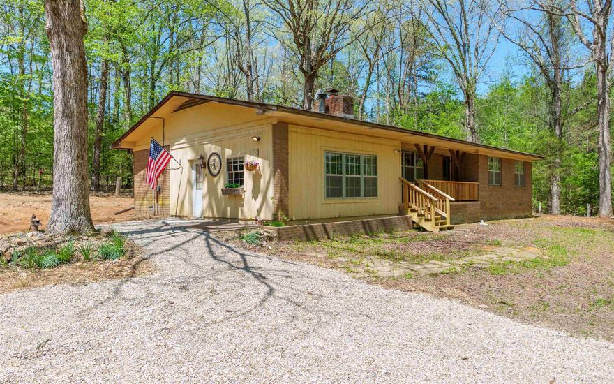 Perfectly Located on 1 Serene Acre just a few miles from Jessieville School!  Cozy around the fireplace this winter in the spacious living-room, or spend quality  family time movie watching or gaming in the large den with it's own cozy stove. You might also enjoy front porch wildlife watching and listening to the rippling nearby creek.  This 3 bedroom 2.5 bath home has a primary suite with primary bath and a large walk-in closet, 2 large guest bedrooms, and over-sized laundry room/utility room with a sink and shower for quickly cleaning up after playing or planting outside.  There are several updates includinga New roof 2023 and New hot water heater 2023..Other new updates include: a new vapor sealed crawlspace, & new flooring in kitchen, dining, and laundry-room. This is price to sell quickly! Don't Miss Out!!