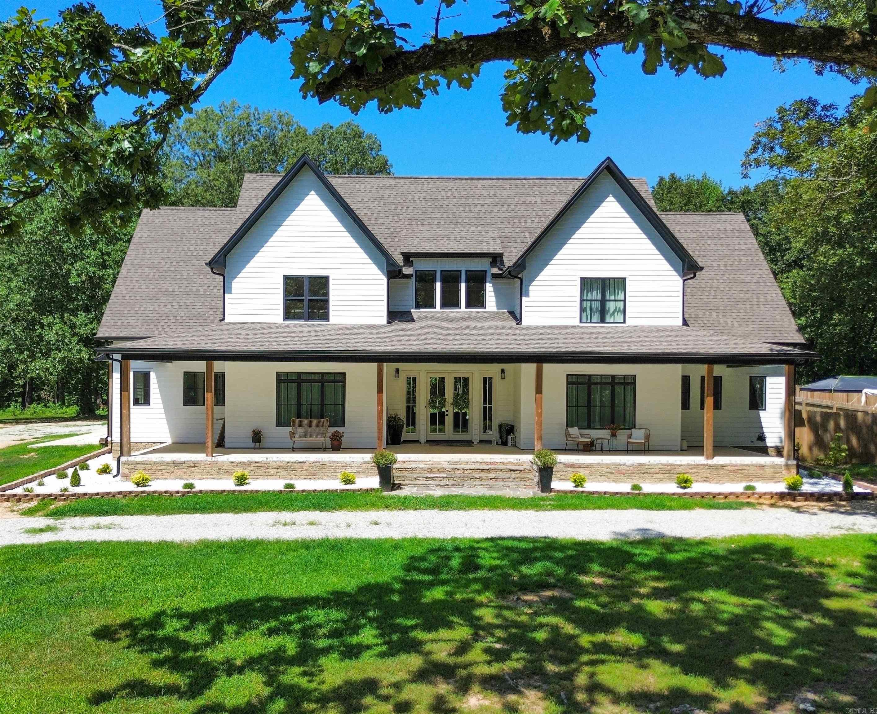 Welcome to this stunning custom-built modern farmhouse on 20 peaceful acres (+/-), offering over 4,500 sq ft of luxury and charm. This 4-bedroom, 4-bath home features soaring ceilings, high-end finishes, and an open-concept design perfect for gatherings. The gourmet kitchen boasts a coffee bar, a hidden scullery for added prep and storage, ample pantry space, and flows seamlessly into spacious living and dining areas. Two flexible bonus rooms can be used as offices, additional dining, or storage. A guest suite upstairs adds comfort for visitors! Step out back to your personal retreat with an in-ground pool, oversized covered patio, hot tub, and beautiful views. This property also showcases a 900 sq ft guest house with a covered front porchāmaking the total living space out to be nearly 5,500 square feetāperfect for extended family or rental income. More great features included are a spacious shop with a slab foundation and dual overhead doors ideal for projects or storage, a roomy 3-car attached garage, a fully fenced garden area ready for planting, and a generous covered front porch that welcomes you home with timeless charm. Refined country living at its finest!
