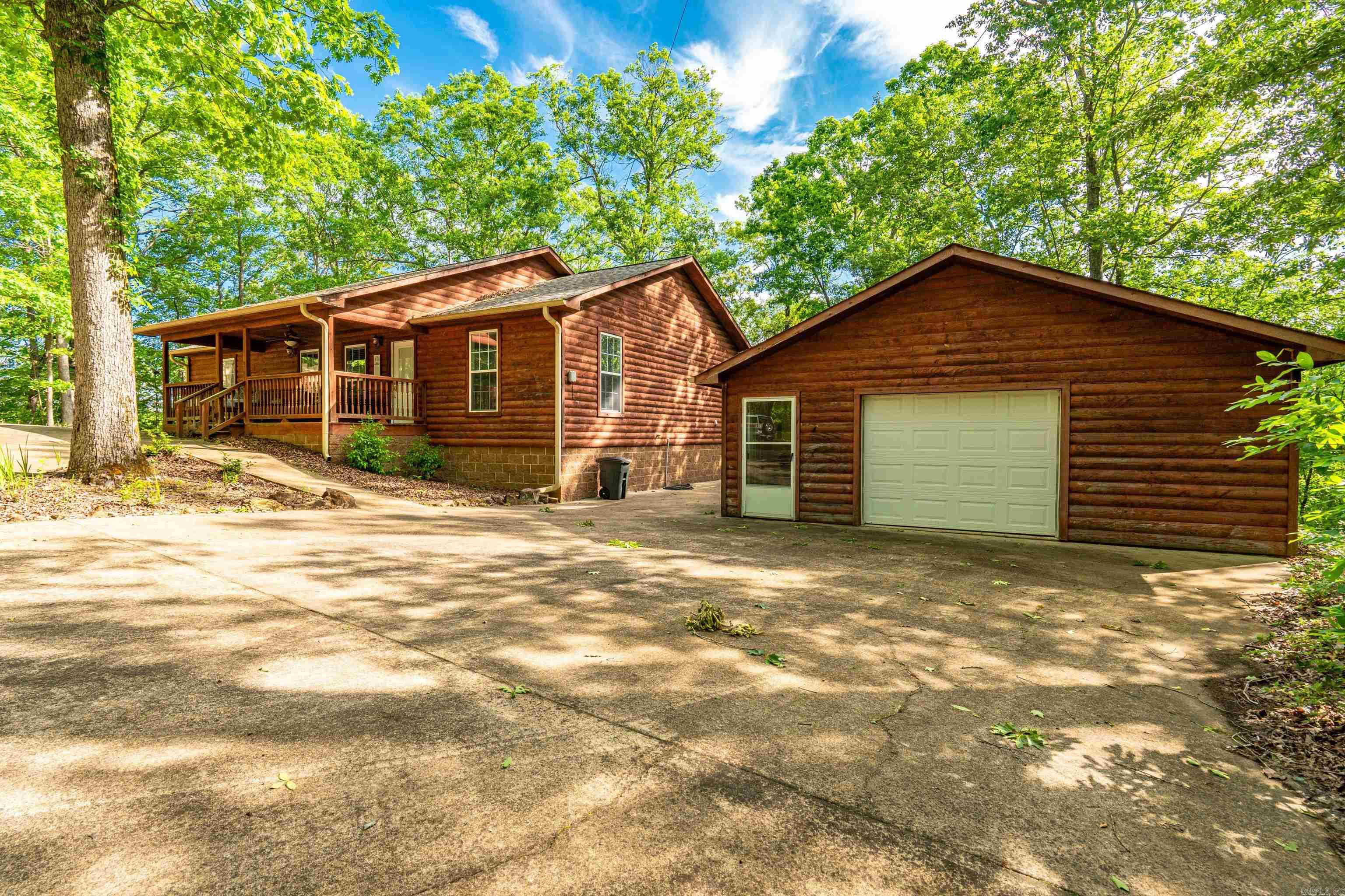 Perfect getaway for weekend or awesome full time residence.This home is tucked away under the trees on Lake Greeson with lake access,plus mountain views. Home has been used as a VRBO and seller is leaving everything! Fully furnished from kitchen and appliances ,laundry to linens.living room furniture ,!Very well maintained and ready to move right in.Gas log fireplace ,RV hook-up.24X16 deck off the back of the 25X25 shop on slab (with power) 36X12 heated and cooled sunroom off kitchen with amazing view of the lake!Multiple outdoor entertaining spaces.Rooms are large and spacious.Open concept living,kitchen and dining. The ultimate in private lake living! By Appointment Only!
