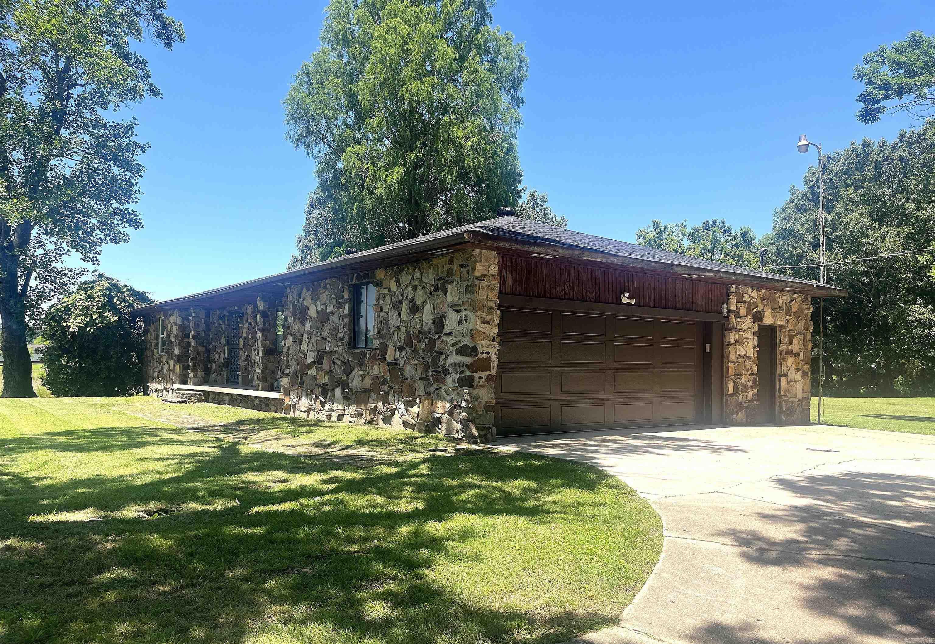 Tired of close neighbors? Need some outside space? This move in ready home on 2 acres may be perfect for you! The seller has replaced the roof, installed new central heat and air, new water heater, new counter tops, new patio door, and new garage door and opener! It also has new laminate flooring, fixtures, and fresh paint throughout!! The home has 2 BR, 1 bath, large living area, a dining area and large laundry/mud room off the garage. There is also an outside storage area off the garage. A must see!
