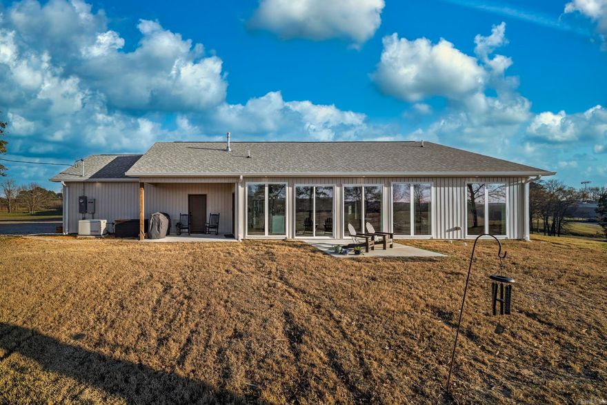 Just completed in May 2025, this stunning 2 bedroom, 2 bath home in Bismarck, Arkansas offers modern design, energy efficiency, and breathtaking views on 6.22 acres in Hot Spring County. With 1,428 sq ft, the open-concept layout features durable LVP flooring, custom cabinets, quartz countertops, and an oversized island ideal for entertaining. Automatic blinds throughout add both style and convenience.  Built with long-term comfort in mind, this home includes central heat and air, a tankless water heater, whole-home generator, and an additional 14 inches of insulation for enhanced efficiency. The spacious primary suite offers a large walk-in closet, and 36-inch doors provide easy accessibility throughout.  A floored attic offers excellent storage and is designed to convert into loft living space if desired. Outside, enjoy a covered patio with scenic views, an oversized 2-car garage, and a 30-amp RV hookup.  If you’re searching for a new construction home with acreage in Bismarck or Hot Spring County, this move-in ready property delivers privacy, quality, and space to grow.