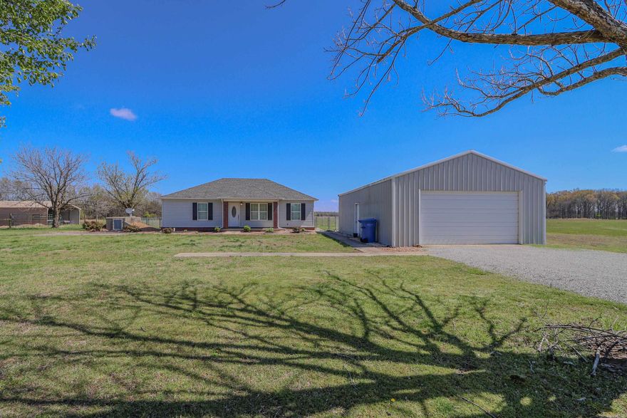 Discover the allure of this captivating newer residence nestled on 34.3 acres of picturesque land. Embrace the modern comforts of a spacious granite kitchen, complemented by a versatile flex room and a large walk-in laundry room for added convenience. Experience the harmony of indoor-outdoor living with cross-fenced grounds, barns, and a well-equipped shop, all while ensuring safety and peace of mind with a dedicated storm shelter.