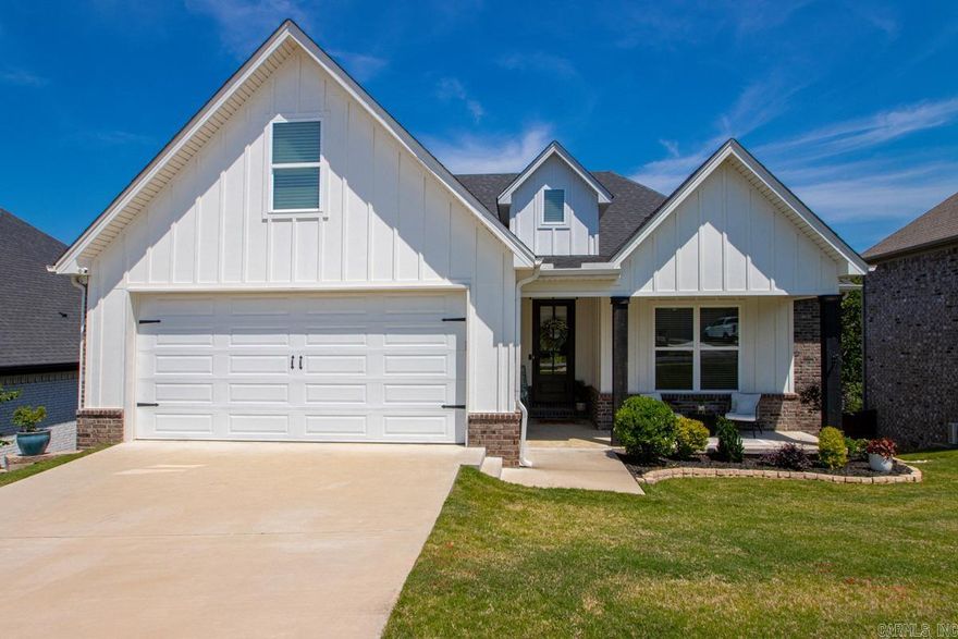 Welcome to 184 Ridgeview Trail, where scenic views and thoughtful design meet in a prime location. Backing to green space, the home features metal rod fencing and a matching upper-deck railing for elevated outdoor living. Inside, the open-concept layout is filled with natural light on both levels. The kitchen offers quartz countertops, ample cabinetry, a coffee station, and a walk-in pantry. From the garage is a mudroom next to the laundry room. The primary suite overlooks the backyard and includes a makeup nook and remote-controlled blinds. The en-suite bath features a double vanity, walk-in shower, soaking tub, and private water closet. The main level also includes a second bedroom and full guest bath. Downstairs, with access to the lower deck, you’ll find matching hardwood floors, a flex space, two more bedrooms, and a full bath. Upgrades include additional window coverings (including a Roman shade on the front door), recessed lighting above the garage, a Bluetooth-enabled whole-yard sprinkler system, and professional landscaping with stonework and steps to the rear gate. The walk in crawl space has a floored area for storage.