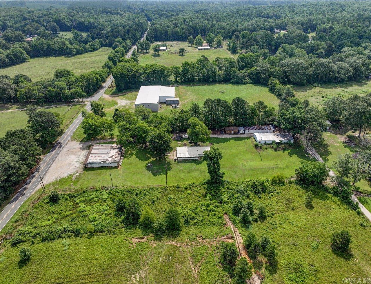 Charming old farmhouse with shops, storage buildings, and historic grocery store on 2 acres. Step back in time with this unique and versatile property on 2 acres of countryside charm. This classic home offers the perfect canvas for restoration or creative reinvention. Adjacent to the house (1440 sf), you will find two sizable shops (shop 1=1960 sf and shop 2= 1440 sf) ideal for wood working, automotive work, or small business operations. Additional storage buildings offer ample storage for equipment and tools. Adding even more potential, the property includes an old historic grocery store building that could be restored as a retail space, studio, or unique venue. This property offers a rare opportunity for homesteading, small business ventures, or quiet country retreat. Addresses are 3669, 3671, and 3673 Amity Rd.