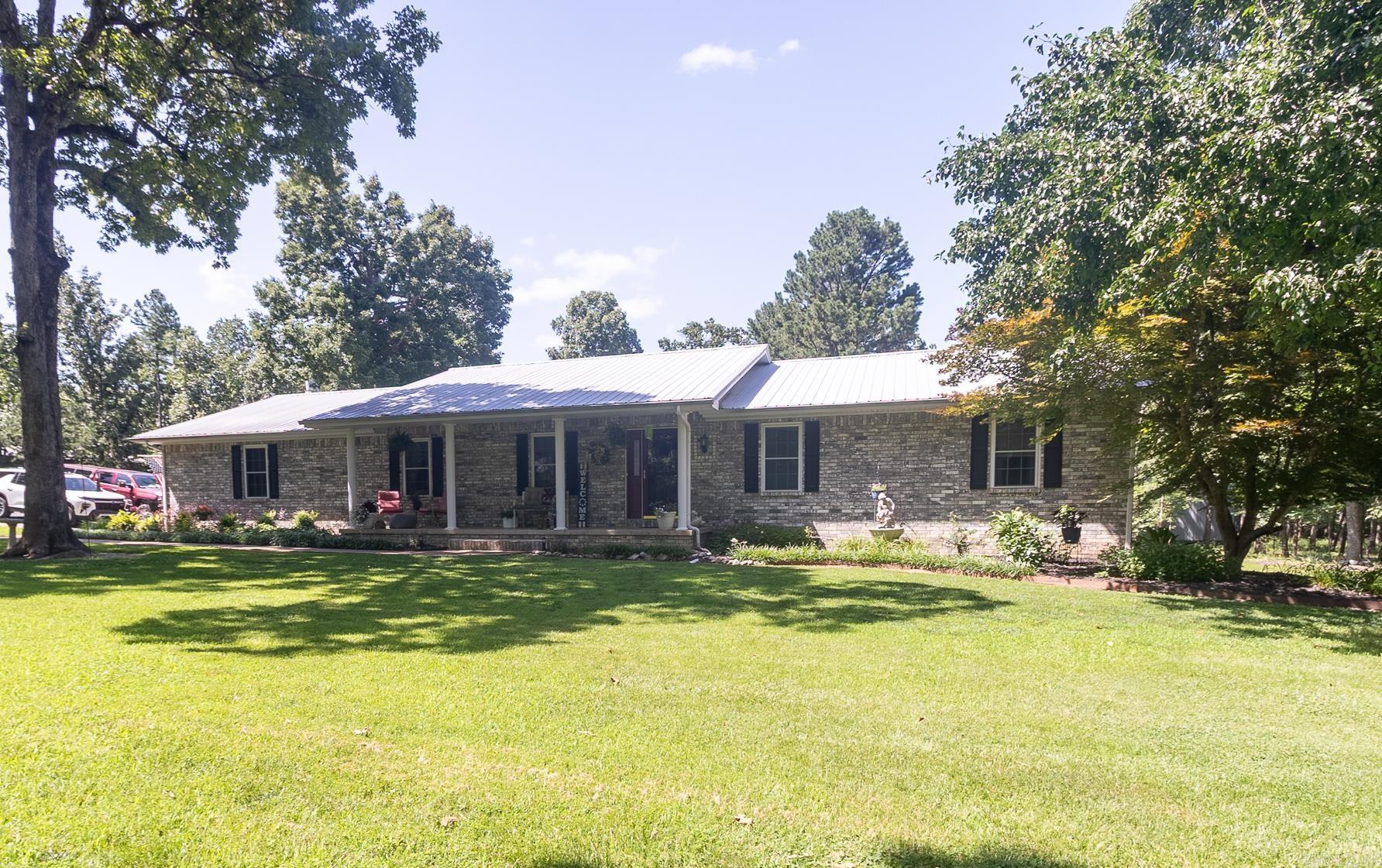 This stunning property offers both a beautiful home and an income-generating guest house. The main residence features three bedrooms and three bathrooms, showcasing elegant hardwood and tile flooring, custom oak cabinetry, and Corian countertops. A sunroom with a hot tub adds to the charm, while a whole-house backup generator ensures reliability. The guest house, measuring 1,268 square feet, includes two bedrooms, one bathroom, and a one-car garage, all recently updated with new insulation, ductwork, and luxury vinyl plank flooring. Two-thirds of the guest house furniture is included in the sale. Additionally, the property boasts a spacious boat shop and an RV shop equipped with a 14-foot overhead door, along with a zero-turn lawn mower and a large air compressor. An RV pad with separate electric, well, septic, and propane tank. Set on a beautifully landscaped 3.33 acres, this property is conveniently located just two miles from Tracy Marina. $725,000