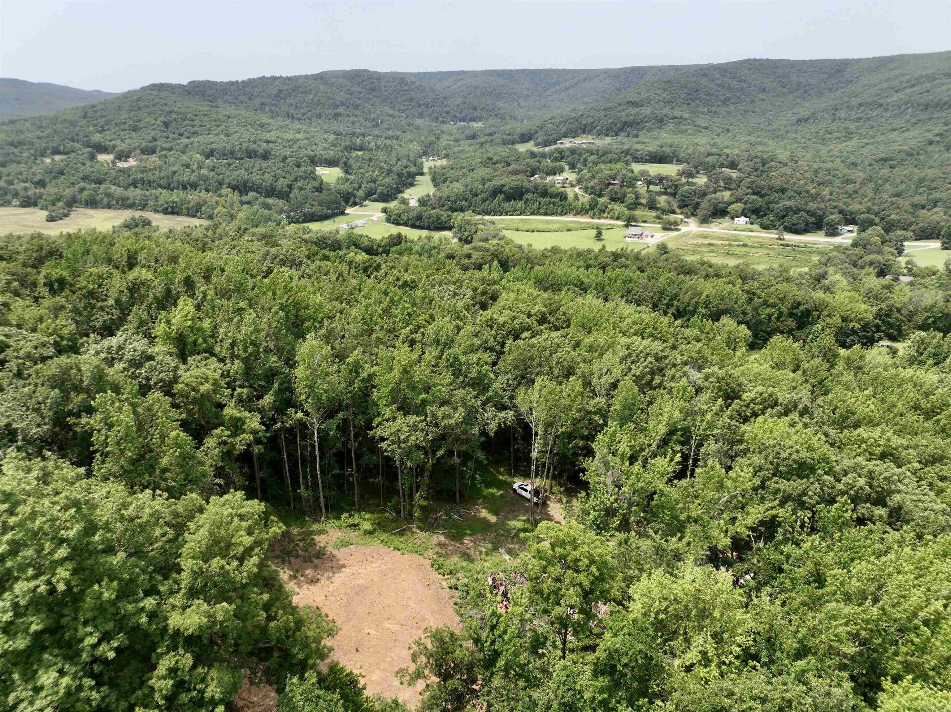 Nestled just a short drive from the vibrant city of Fayetteville, this stunning property offers a unique blend of convenience and seclusion. The location is ideal for outdoor enthusiasts, only minutes from the expansive National Forest. Whether you're looking to explore the scenic trails or simply enjoy the tranquility of nature, this property has it all. One of the key highlights of this site is its proximity to the Mill Creek OHV trailhead, a favorite spot for off-highway vehicle adventures. The property itself features a spectacular build site, complete with a buildable pad and driveway already in place, making it easier for you to start your construction project. Electricity is conveniently located nearby, reducing the cost and hassle of utility setup. However, prospective buyers should note that a water well must be dug. Once completed, this will provide a reliable water source for your new home. This site's panoramic views are breathtaking, offering a perfect backdrop for your dream home. Surrounded by large, mature timber, the property ensures privacy and seclusion, creating a serene environment.