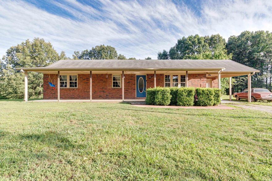 Nestled amidst the serene beauty of southern Greene County, this meticulously maintained all-brick ranch-style home exudes relaxation and charm. A welcoming covered front porch welcomes you into a place where nature and comfort blend seamlessly. Offering 3 bedrooms and 2 bathrooms, this residence features a delightful sunroom that extends to an expansive deck overlooking the gently sloping backyard with plenty of wildlife. Set on a picturesque 4.39 +/- acres, every corner of this property whispers tranquility. Recently renovated with attention to detail, enhancements include plush new carpet in all bedrooms, freshly painted kitchen cabinets complemented by stainless steel appliances, and updated bathrooms. The addition of insulated windows and doors ensures energy efficiency. A standout feature is the spacious 16'x20' storage building accompanied by a convenient 9'x20' lean-to for additional storage. Located within the Greene County Tech school district, seize this opportunity to embrace a lifestyle before it slips away!