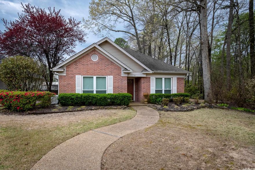 Private setting, one level located at dead end street, back load 2 car garage. Many updates - plantation shutters throughout, all hardwoods, open floor plan, whole house generator, and extensive landscape. Outdoor living - retractable awning on patio, gas grill connection, fully fenced, backs up to AR Game & Fish. Vaulted den - built-ins and floor to ceiling stone fireplace. Large dining or office, split floor plan, pantry, cedar closet, sprinkler system. Well insulated home for buffering interstate 430 traffic. Agents - Security System is on!