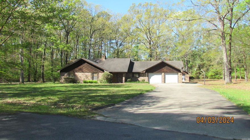 Beautiful Country home in Move-in Condition sitting on 1.80 Acres with 1904 Sq Ft, with wood burning fireplace with wood mantle and brick wall, large living area with cathedral ceiling, windows overlooking a concrete deck and large backyard,  two full baths, large master bath with walk-in tile shower, double sinks, large walk-in closet for Large master bedroom, hall bath has tile shower over  bathtub and large vanity, and also Two  large bedrooms with large closets.  The large kitchen features breakfast bar open to dining room with double door leading to the large living area with fireplace, built in microwave, oven and stove top,  dishwasher, refrigerator, lots of cabinets and walk-in pantry.  Home was  built in 1986 and features central heat and air, large concrete patio with wood rails, extra single garage/storage building with electricity,and extra storage building.  Blacktop long driveway leads to the Double Garage with storage and pull-down stairs to attic and a side driveway leading to the storage building.  Large yard has beautiful trees and landscaping.