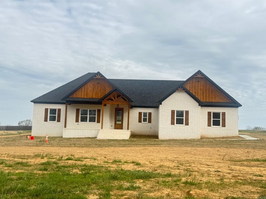 Beautiful New Construction featuring 4 bedrooms and 2.5 bathrooms. This open-concept floor plan makes excellent use of every square foot. The spacious kitchen includes a large island, and the living area offers a cozy fireplace. The laundry room features a locker-style drop zone, and the closets come with built-ins for added organization. Enjoy outdoor living on the covered back porch, perfect for entertaining. The home also includes a partially floored attic for extra storage. All of this sits on approximately one acre. Taxes are estimated on the lot only. This is a must-see! PROFESSIONAL PHOTOS TO FOLLOW !!!!!!