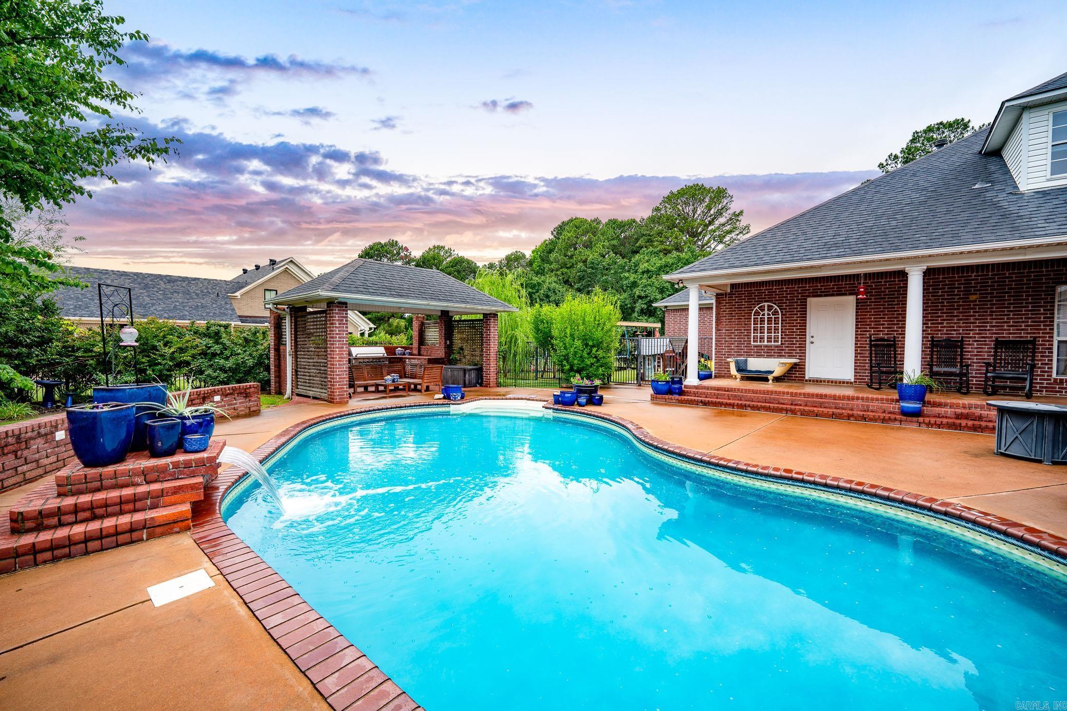Let the good times begin! Family and friends will love the summer days swimming and cooking out. The salt water pool with the waterfall feature invites everyone to take a dip and cool off. The kiddos have an area separated from the pool to play without a worry. The first floor has 4 bedrooms and 3 baths. The school room has a large closet if a 5th bedroom is needed. The utility room is large with lots of cabinets & storage. The kitchen is amazingly open with a Thor 6 burner range for preparing those holiday gatherings. Corner lot on Centennial Golf Course.