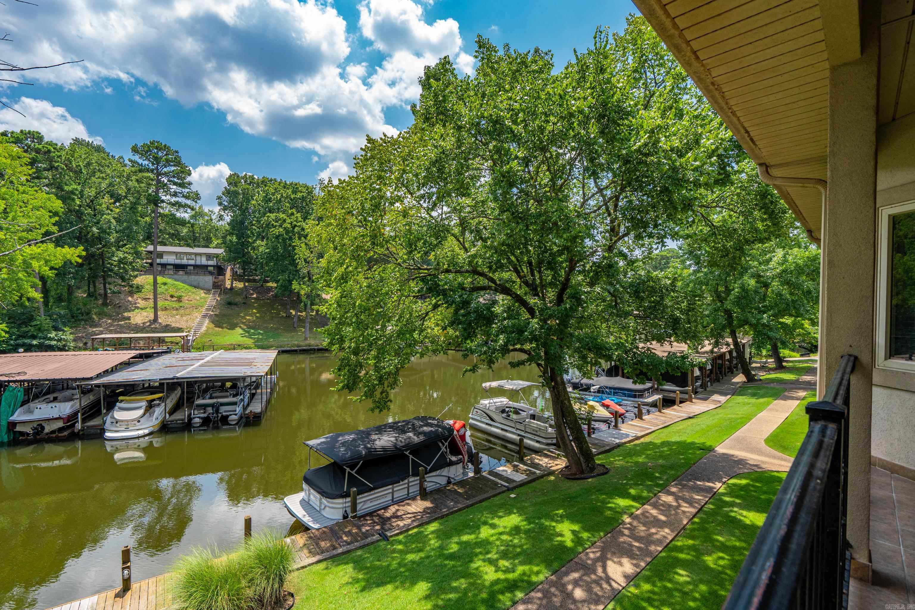 Stunning fully furnished 2-bed, 2-bath condo in a peaceful cove, perfect for relaxation and water activities! Enjoy granite countertops in the kitchen and bathrooms. Private boat ramp and boardwalk that you can tie off to. Go fishing or simply soak in the serenity of the water. Exclusive access to a community pool and poolside cabana. Also, has parking space for trailer.