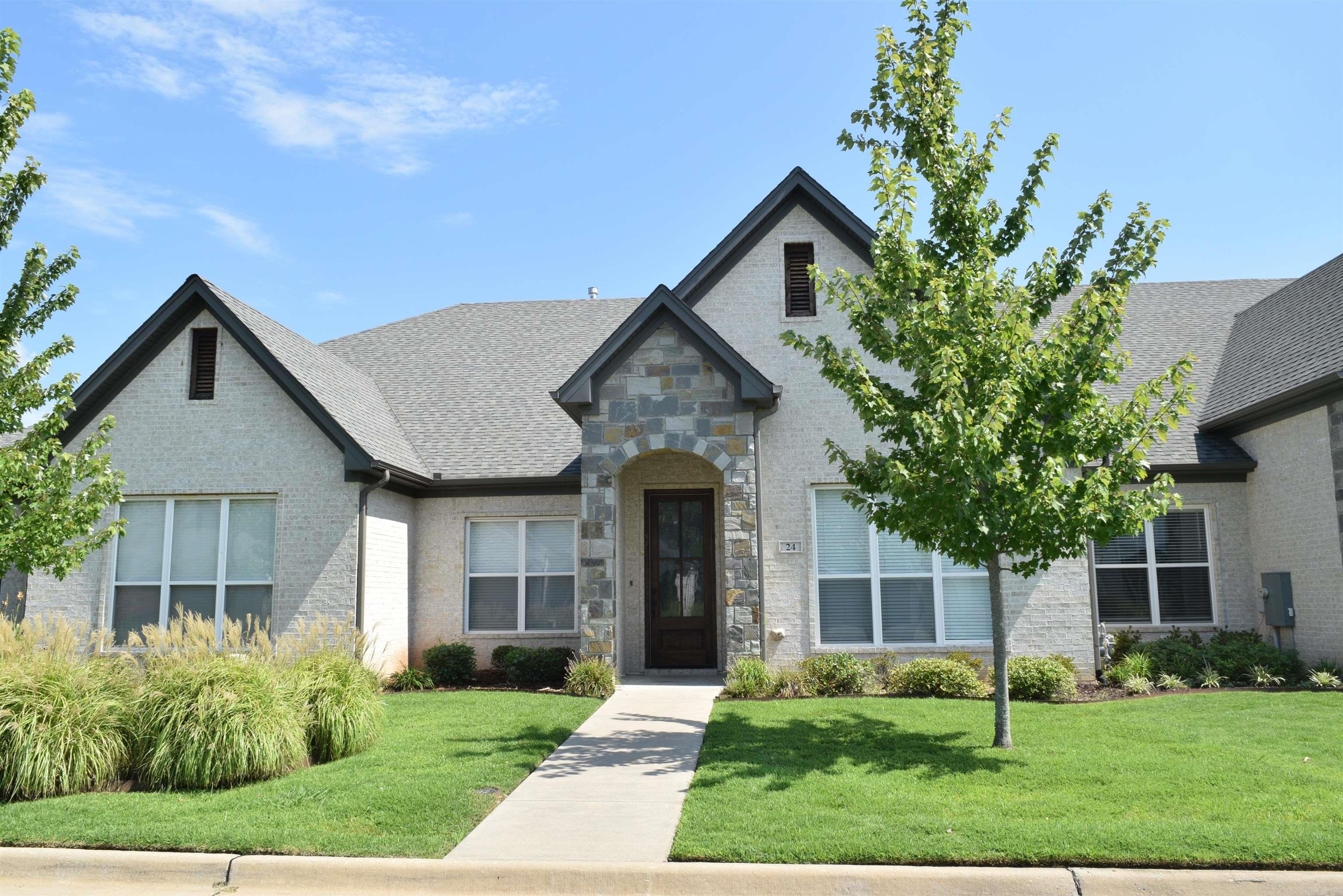 This is an attached home in a newer neighborhood convenient to restaurants of the Promenade, groceries and WLR/Chenal opportunities. Features include under cabinet lighting in the kitchen, trash cabinet, smooth surface LG range, Whirlpool french-door refrigerator, new dishwasher, island, walk-in pantry, Leathered granite countertops and dining area. There is a Laundry room which includes a Whirlpool stackable machine. The rear loading 2 car garage is accessed through a common alley way. The back porch is covered and offers access to a small grassy fenced yard which is maintained by the association if the fence is left unlocked. There are 2 bedrooms, both with walk-in closet and individual bathrooms with granite countertops. The primary bedroom offers an ensuite with a walk-in shower and a two sink vanity. This room also offers a vaulted ceiling. The open great room provides a gas log fireplace. Some other features of the home include 10' ceilings, recessed lighting, tankless hot water system. As previously mentioned, the yard is maintained year round by the association. This is an attached individual home, not a condo.