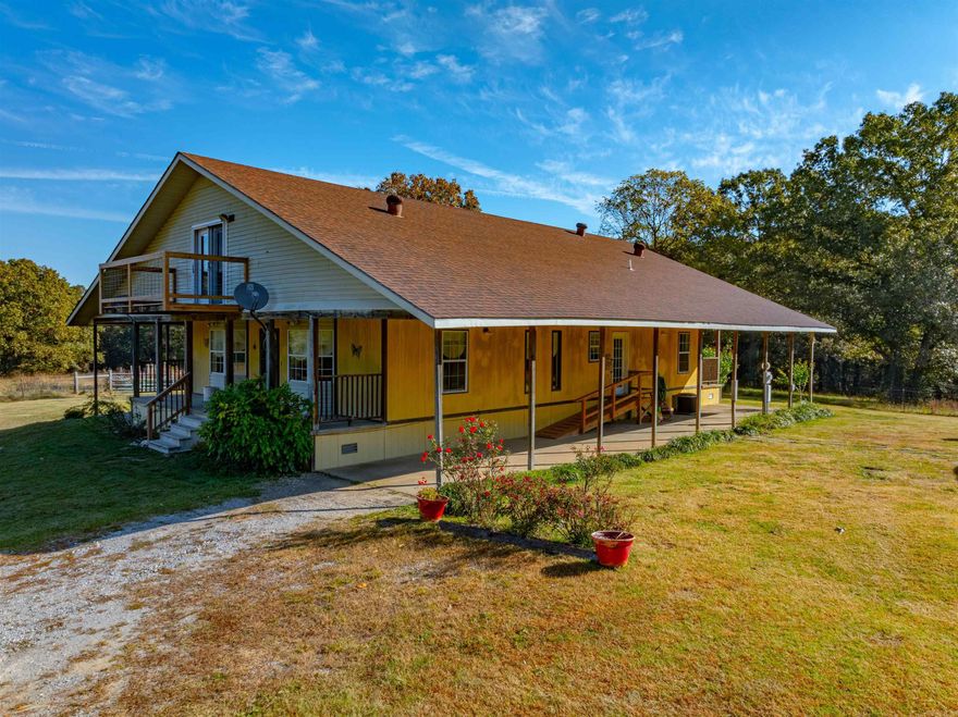 57 +/-acres just minutes from Cave City, Ar, sits this magnificent property offers unparalleled privacy and beauty.Accessed by a private, gated driveway, the expansive home boasts over 5,400 sq. ft. under roof,with 5 bedrooms, 5 bathrooms,and plenty of space to spread out.Nestled in the peaceful Ozarks, this property is a true piece of heaven.Main floor features 3 spacious bedrooms, 2 full bathrooms, and a bath located off the laundry room.Large living room flows seamlessly into a dining area situated between the kitchen and living space.The laundry room also offers ample pantry space, adding to the home's functional design.Both sides of the house are flanked by covered porches that run the entire length of the home, offering incredible spaces for relaxing, grilling, and soaking in the tranquil surroundings along with front and back porches.Upstairs,you'll find two spacious bedrooms, each featuring its own private bathroom,large closet, and private balcony–perfect for enjoying peaceful mornings or starlit evenings.These two bedrooms are separated by a cozy sitting area and a convenient kitchenette, equipped with a countertop stove, fridge, and counter space.