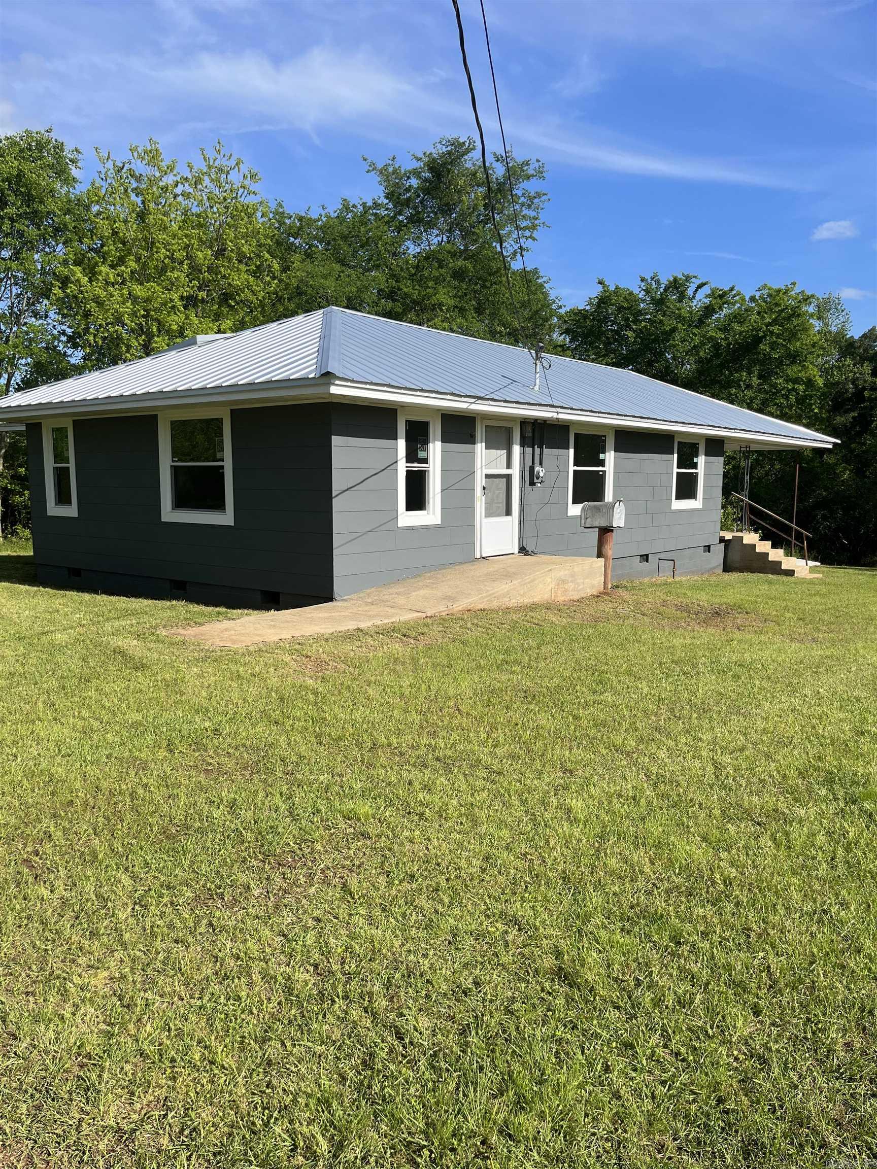 Excellent price for 15 acres. This remodeled and updated home is waiting for your finishing touches. It has updated plumbing, electrical, windows, paint inside and out. It sits on 15 acres of land. You will not find this anywhere else in Ouachita County. Home is handicapped equipped. Land is gently rolling and has numerous uses. Let your imagination and creativity go wild and come see this property. Deer and Turkey abound in the area . Gas easement runs south of the home and provides gas service to the property. One of only a few homes in the area with gas. Concrete ramp, wider doorways makes it easy to get around in. 2 antique barns are in back. Has a nice covered deck on the back. There are possibilities that cannot be advertised publicly at this time. Call for appointment. Under contract backup offers are being accepted.