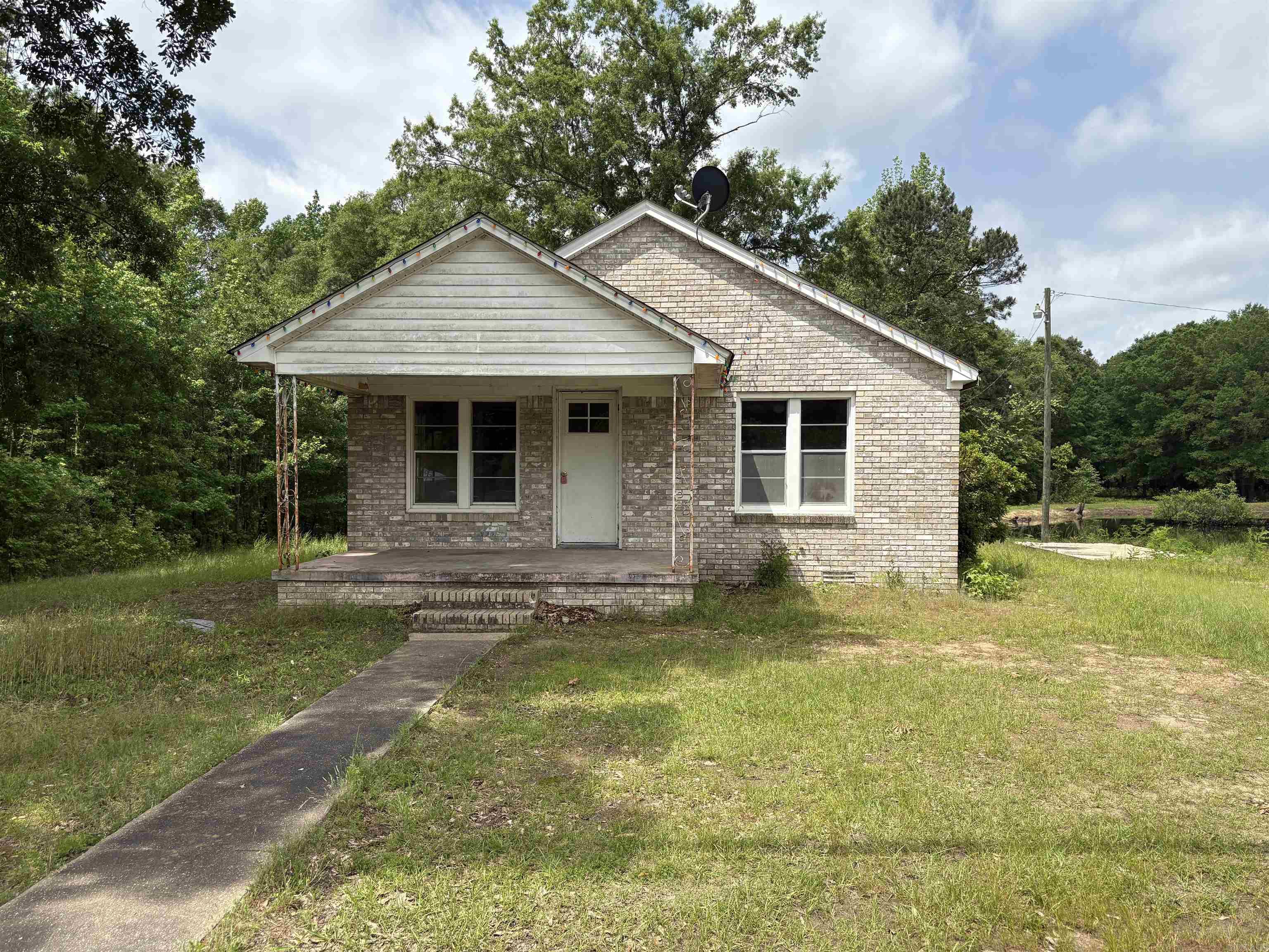 Discover this solid all-brick property situated on a generous 1.5-acre lot in a prime location. This home has a proven track record of consistent rental income, making it an excellent option for investors or first-time buyers looking to build equity while paying less than rent. The expansive lot provides a unique opportunity for a potential lot split—perfect for constructing an additional residence or simply expanding your investment portfolio. The seller is open to negotiating certain repairs and updates. Whether you're planning to live in it, rent it out, or develop further, this property is full of potential. Don't miss your chance to own a versatile property with land, location, and options: Build, Rent, or Own for Less Than Renting