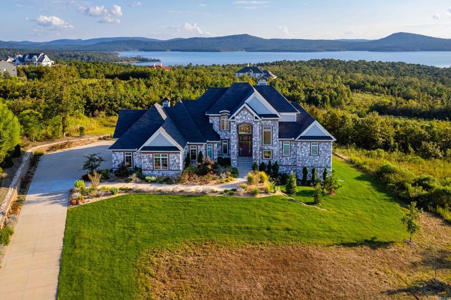 Welcome to this stunning custom 5 BR, 4.5 BA home built with functionality in mind. The main level features a spacious primary suite with a spa-like bath including a large walk-in shower, soaking tub, heated floors, double vanity & oversized closet. Enjoy an open living room with beautiful views of Lake Maumelle and abundant natural light. The chef’s kitchen boasts Thermador appliances, eat-in breakfast area, and flows into a bright sunroom with patio access. A hearth room or sitting area is conveniently located off the primary suite. Downstairs offers a large living room with walkout access to the backyard plus 2 bedrooms and 2 bathrooms, while upstairs includes two bedrooms, two bathrooms, and a large bonus room with walk-in attic access. Additional highlights include a 3-car garage, hardwood and tile flooring, tankless water heaters, high-efficiency HVAC, and extensive storage throughout. Access to trails, parks, tennis courts, and scenic views all within the gated Waterview Estates.