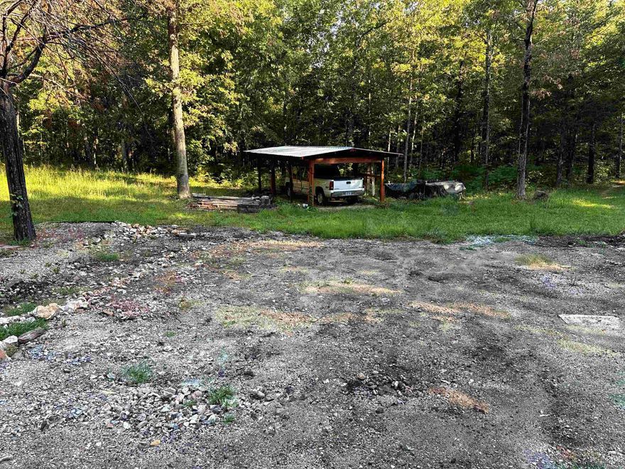 Discover this beautiful 6.56-acre parcel, offering a private setting surrounded by nature. With essential utilities already in place, including electric, septic, and well water with a brand-new well pump, this property is ready for your home or weekend getaway. The landscape is a haven for deer and other wildlife. The property also includes a convenient carport, perfect for protecting your vehicles or outdoor equipment. Plus, with NEXT internet available, you can stay connected while enjoying the tranquility of the outdoors. Located just 1.5 miles from Strawberry River access, you'll have easy opportunities for fishing, kayaking, and enjoying the water. Whether you're looking to build, hunt, or simply escape to nature, this land provides endless possibilities. The RV does NOT convey. D