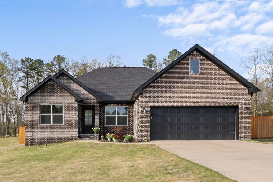 Welcome to this stunning, newly built 3-bedroom, 2-bath home located in the desirable and established neighborhood of Little Red River Estates with access to the boat dock and boat slip. Built in 2023, this modern home offers a spacious open-concept kitchen and living area—perfect for entertaining—with a cozy fireplace featuring gas logs as the centerpiece. Enjoy outdoor living year-round with a covered patio and a fully fenced backyard, ideal for relaxation or gatherings. The property includes a covered RV parking area (16x50) built to match the home’s beautiful brick exterior and an attached shop with 50 amp service for added convenience. Nestled just a short walk from the Little Red River, residents enjoy dock access for fishing, kayaking, or peaceful waterfront views. You're also just minutes away from downtown Heber Springs and the sparkling waters of Greers Ferry Lake, making this home a dream for nature lovers and outdoor enthusiasts. Don’t miss the opportunity to own this gorgeous home in one of the area’s most sought-after communities!  AGENTS - see remarks!