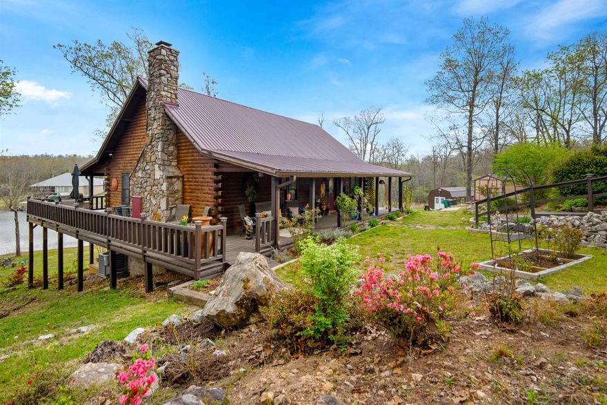 UNIQUE DREAM PROPERTY- A TRUE "UNICORN' ON DIAMOND LAKE! Opportunities like this are rare. Acreage on a beautiful lake!! About 2.64 acres with an impressive 536 feet of private LAKE frontage, this stunning 2734 sq ft LODGE log home offers the perfect balance of seclusion, recreation, and refined rustic living.  Whether you're seeking a peaceful retreat or an adventurous lifestyle, this property delivers.  Enjoy fishing, kayaking, and exploring the wooded section of your land. Immerse yourself in nature and enjoy the abundant wildlife including deer and turkey. Inside, the home showcases beautiful hardwood floors, soaring ceilings, and a grand natural stone fireplace that anchors the main living space.  A loft above overlooks this striking centerpiece, adding both charm and architectural appeal. The primary en-suite is designed for comfort and relaxation, featuring a jetted tub and a walk-in shower.  Upstairs, the guest room offers its own sitting area and full bath. Downstairs is a large open den/family room, expansive windows overlooking the lake and another private guest room and bath.  The kitchen is open to the living area and has granite countertops. Must see and experience!