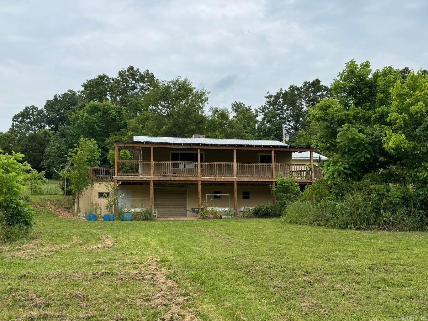 Come sit on this wonderful covered deck and listen to the creek and enjoy the peace and quiet. This 2 bedroom 2 bath home on 3.46 acres +/- has a barn with a fenced area, and lots of fruit trees. Home features a large kitchen with tons of storage, dedicated laundry, primary bedroom with a huge walk in closet, large covered deck, and a workshop area in walkout basement. The HVAC was replaced in 2024.
