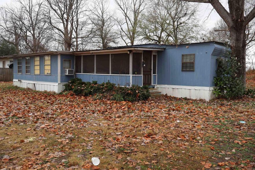 Three-bedroom, two-bath mobile home located along Connerly Bayou, which connects directly to Lake Chicot. This property offers a simple setup in a well-known fishing area, making it suitable for a camp, weekend retreat, or recreational use. The property includes a large lean-to with storage and additional enclosed storage for gear or equipment. It also already has a covered dock with deck, making it ready to enjoy the water and fishing access right away. The property offers a solid footprint in a desirable waterfront location with excellent fishing access and room for improvement. Manufactured home year built is approximate; exact age is unknown. Buyer to verify to their satisfaction.