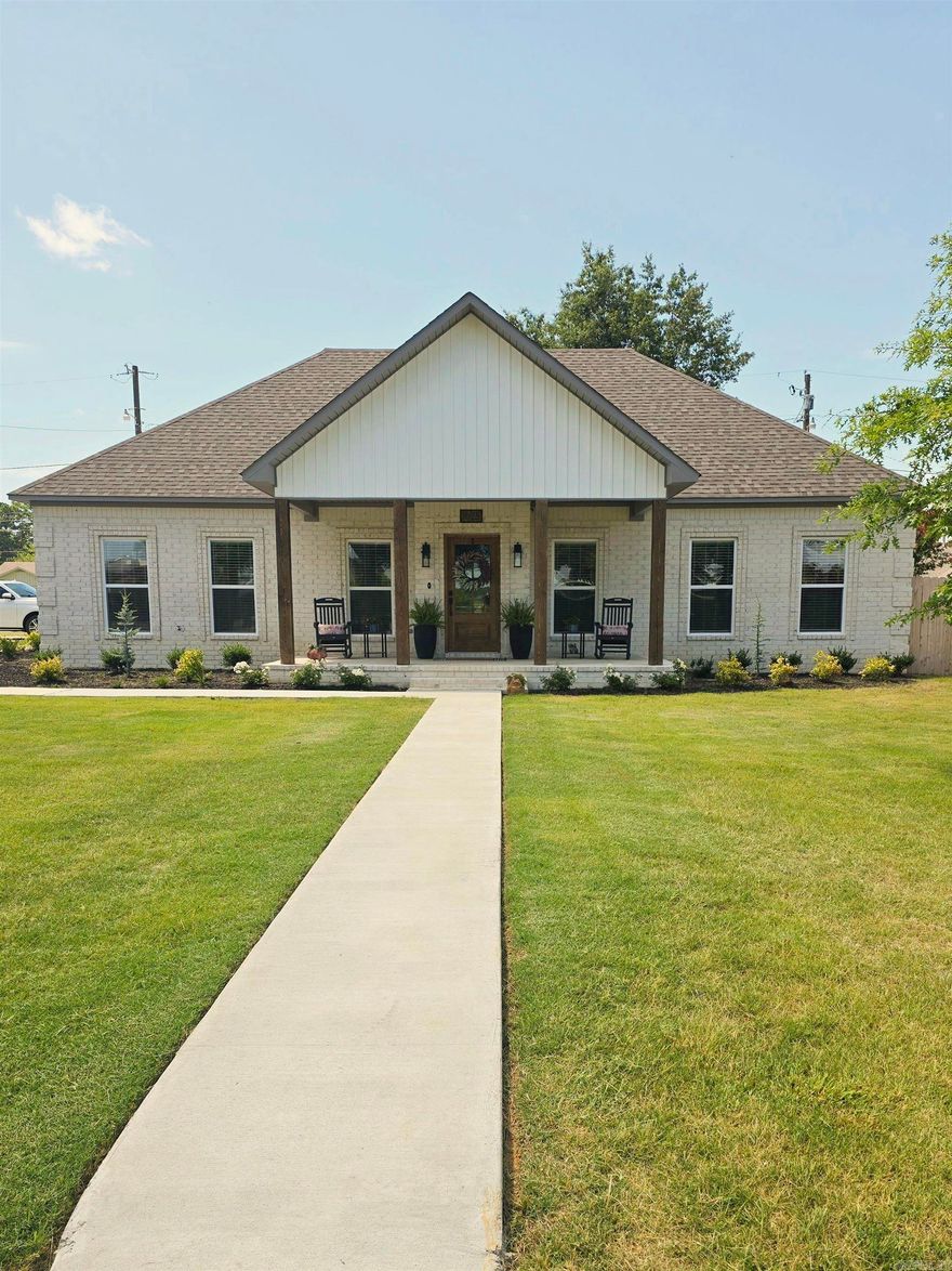 Welcome to Market this beautifully crafted newly built brick home, where thoughtful upgrades and timeless charm meet modern convenience. Located close to schools, this 3-bedroom, 2-bath home on a corner lot with 2 car garage and fenced yard, offers both comfort and style with high-end finishes throughout. Home Features 3 Spacious Bedrooms and 2 Full Baths, Open-concept living area anchored by a brick fireplace featuring a custom 100-year-old heart pine mantle reclaimed from a historic farmhouse. Sliding barn door entry into the primary bathroom and custom shiplap surround adds a designer touch around the jetted tub. Granite countertops have been added throughout the kitchen and baths. Wood front door and solid cedar posts on the front and back porches along with fresh landscape, sod and oak trees have been added for classic curb appeal. Lighting has been upgraded for a warm, inviting glow. Front siding has been upgraded for added exterior style and durability.