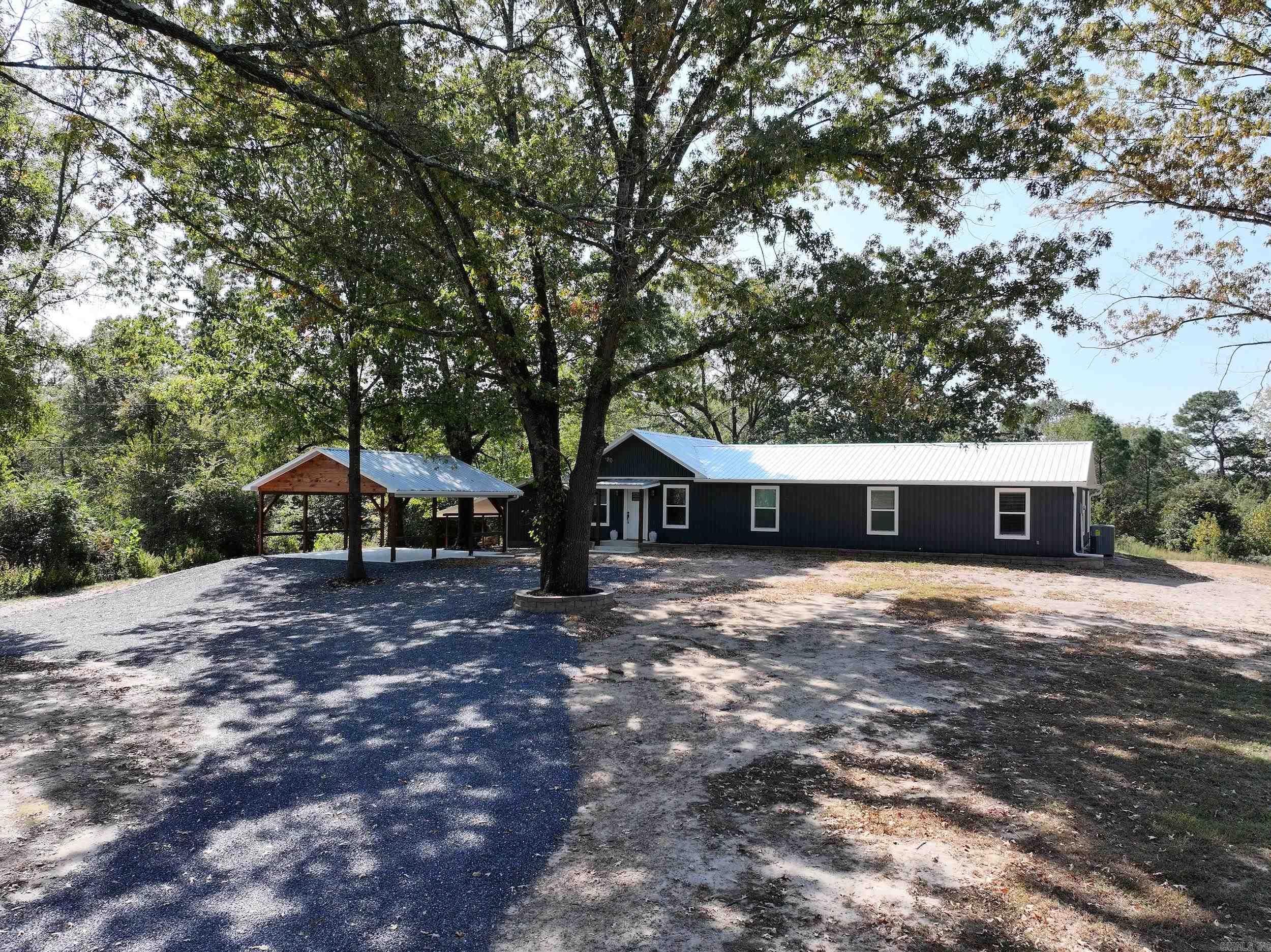 Charming Country Living! This beautifully renovated 4-bedroom, 2-bathroom home offers 1,800± sq. ft. of modern comfort on a countryside lot spanning 4± acres. Every detail has been carefully crafted, with all-new interior and exterior construction, including updated wiring and plumbing. The spacious kitchen boasts brand-new stainless steel appliances, handcrafted cabinetry with soft-close doors and drawers, and elegant granite countertops. A pot filler above the gas stove adds extra convenience, and the bathroom fans even feature Bluetooth connectivity for a modern touch. The primary bathroom is a luxurious retreat with a custom porcelain shower and dual sink vanity, complete with built-in charging ports. French doors in the living room lead to a covered patio, perfect for relaxing as you overlook the expansive backyard and take in the local wildlife. The property also includes a powered outbuilding with plumbing and a lean-to for additional storage. Agent is related to seller.