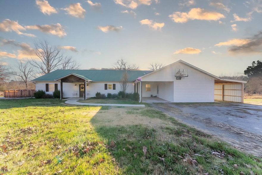 COUNTRY HOME WITH SHOP AND 20 ACRES FOR SALE SALEM ARKANSAS Located at 1468 Hwy 62/412 W, Salem, AR. This Ozarks country home sits on 20 acres at the edge of Salem and offers approximately 2,688 square feet of living space with 3 bedrooms and 2 baths. Additional room that could be used as a 4th bdr. New dual fuel HVAC system, a gas fireplace, and a gas stove. The spacious kitchen boasts custom cabinets, Corian countertops, a pantry, a range, a refrigerator, a dishwasher, and a microwave. The home also includes a large living room area and a man cave/family room.  Outside, you'll find 2 carports, a large covered back deck overlooking the lake, a fenced-in backyard, and a 22-foot above-ground pool sitting on a concrete pad. The property is serviced by rural water and a private septic system, and it has a 500-gallon propane tank. High-speed fiber internet is available.  The 20-acre property is mostly wooded, with a small lake and scattered trees. It's home to plenty of wildlife, including deer, and could be used as a hobby farm. There are no restrictions on the property.