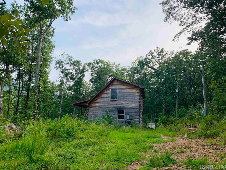 Price drop on this beautiful riverfront property! Motivated seller! Dreaming of a log cabin in the Ozarks, woodland acreage, mountain views, plus rare Little Red River frontage with your own private sandbar? This unfinished 2 story 2 bed/2 bath D-log cabin was constructed by one of the area's premier log home builders. The HVAC, wiring, plumbing, sheetrock, & flooring are completed. It's a blank canvas ready to make it your own. The flowing river below can literally be seen & heard right from the covered front porch with beautiful mountain views right above! The 2017 30X54 3bed/2bath doublewide sits up the hill behind the cabin with an open concept living/kitchen & master apart. With approx 30 woodland acres +/-, river frontage, privately located, 2 septics, large native stone & rock formations, an abundance of wildlife, whitetail deer, birds, & small game this place is a outdoor & nature lover's dream. Power onsite. Doublewide is not on permanent foundation; may be relocated.