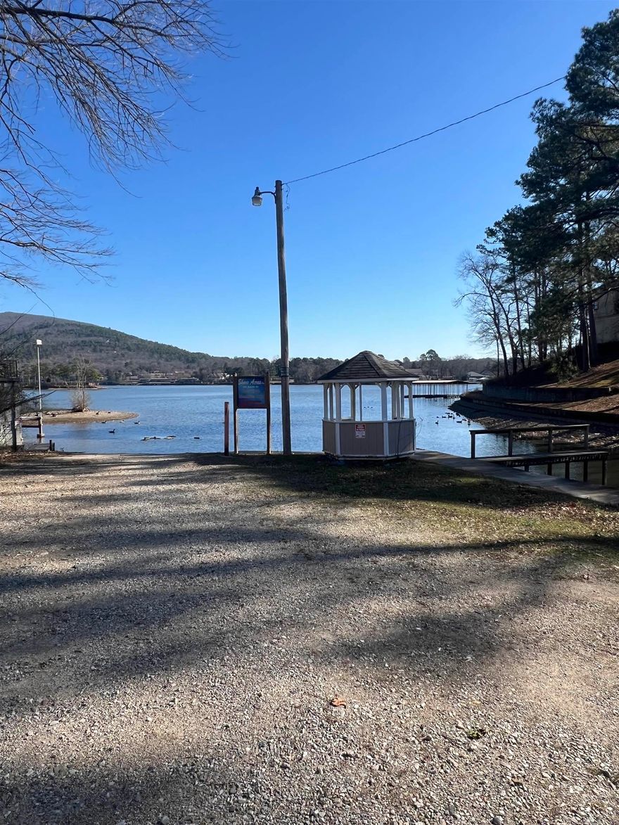 Great vacation home or nightly rental.  This 2 bedroom 1 bath mobile home is located outside the city limits.  Built in 2016, this cute, clean home won't be on the market long.  Also included are a two car metal carport and storage shed.  Conveying with home are 9 lake lots with 5 piers and one gazebo. All located in Shore Acres Boat Club.   Each lot is roughly 10'x20'.  Boat ramp is part of Shore Acres and is used by all members.($40 annual fee for boat ramp). Plat for lake lots is located in the pictures (lots are highlighted in yellow). New roof in 2025