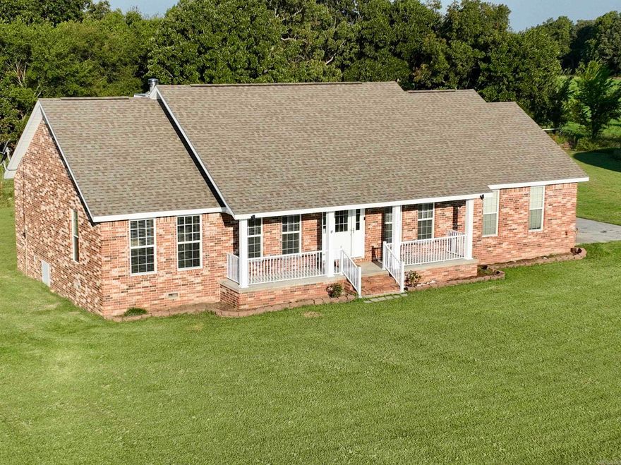 Welcome to your dream retreat nestled just a short drive from Siloam Springs and the vibrant heart of Fayetteville. This gorgeous custom-built home on sprawling acreage offers the perfect blend of luxury, comfort, and natural beauty. As you approach, a private drive welcomes you, ensuring absolute privacy and seclusion. Prepare to be captivated by the breathtaking panoramic views that surround you. The all-brick custom-built home boasts an inviting open floor plan with 3 bedrooms, 3 baths, an office, and a formal dining room. Inside, you'll discover custom oak cabinets throughout, complemented by beautiful tile and hardwood composite flooring. A cozy fireplace insert not only adds charm but also serves as an incredible heat source during cool winter days. The oversized kitchen with an eating bar is a chef's delight, perfect for entertaining family and friends. Step outside to the wonderful screened-in back patio, which overlooks the park-like setting, providing an ideal space for relaxation and gatherings. For your storage needs and projects, a Quonset hut with a built-in shop awaits.